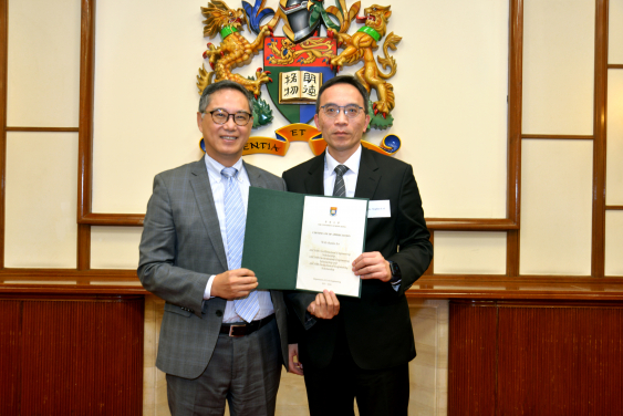 Mr. Stephen Lai (right) receiving a Certificate of Appreciation from Ir. Ricky Lau, JP (left)